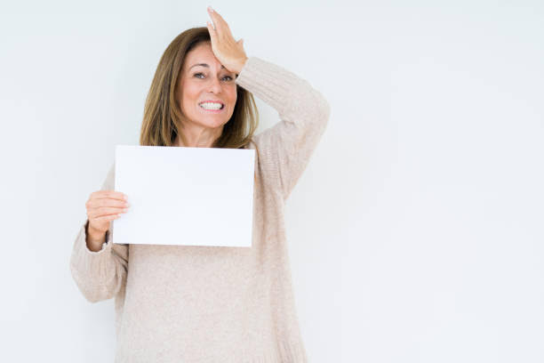Middle age woman holding blank paper sheet